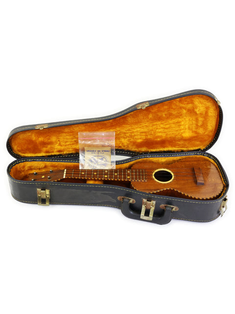 A classic 1924 Weissenborn Miami Style 3 Koa Ukulele resting in a wooden case, exuding timeless elegance and craftsmanship.