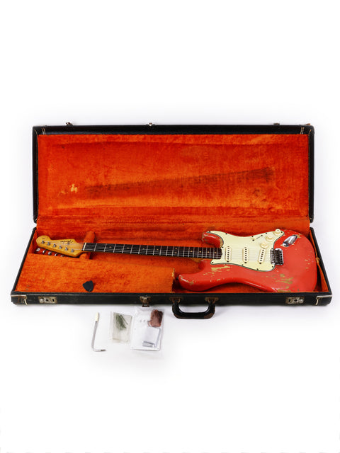 A classic 1964 Fender L Series Stratocaster in Fiesta Red, exemplifying vintage electric guitar artistry and style.