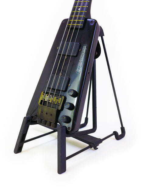 A classic 1982 Steinberger L2 Bass guitar resting on a stand, highlighting its unique shape and vintage appeal.