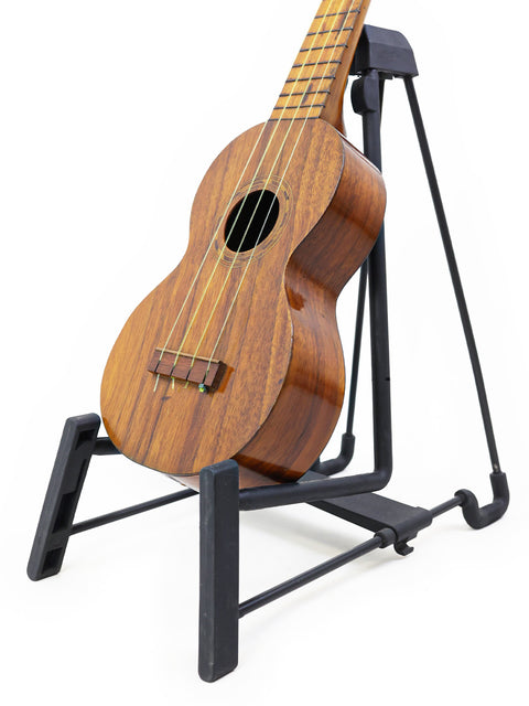 A classic Kaai Style 2 Koa Ukulele, Hawaii, c. 1918, displayed on a stand, showcasing its beautiful craftsmanship.
