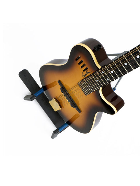 A guitar supports a stand holding a Godin A8 Mandolin, crafted in Canada in 2019, highlighting its elegant features.