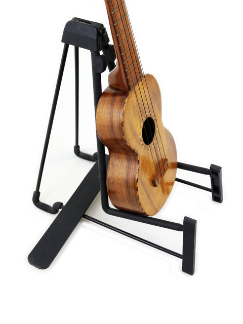 A historic Royal Style 3 Koa Ukulele from Hawaii, circa 1916, positioned on a stand.