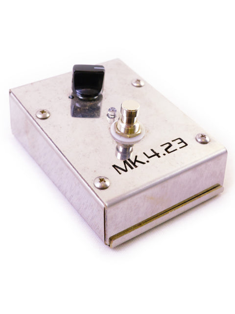 A metal box with a toggle switch and a BNC connector, labeled "MK1.23."