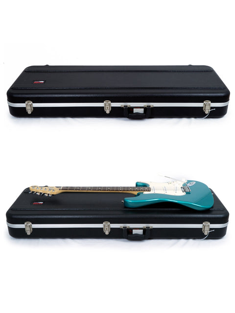 A pair of guitar cases on a white surface, showcasing the Fender 40th Anniversary American Standard Stratocaster from 1994.