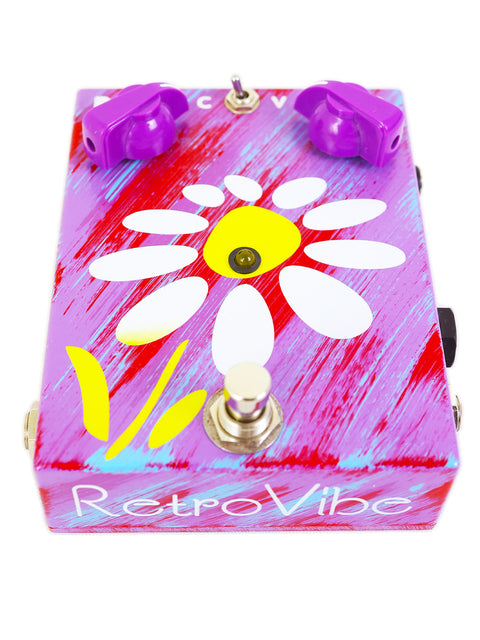 A pedal box featuring a vibrant flower design, labeled JAM Pedals RetroVibe mk.2, crafted in Greece.