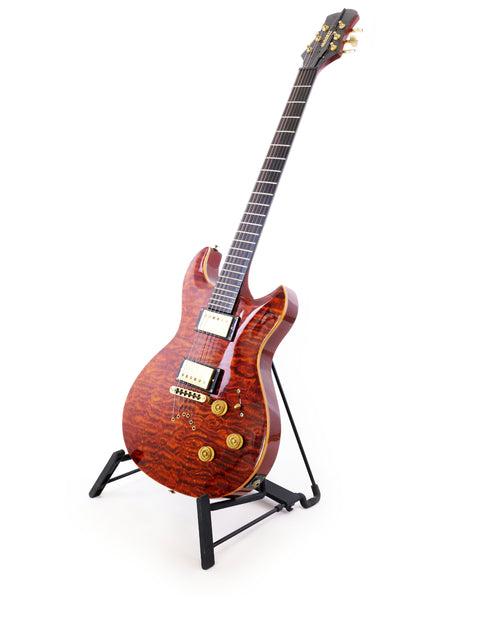  A pristine white background highlights a Jarrett Forza guitar on a stand, emphasizing its unique features and serial number.