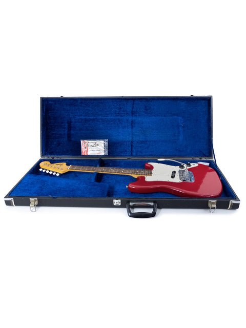 A red 1976 Fender Bronco electric guitar in its case, set on a pristine white background.