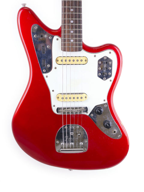 A red Fender CIJ Jaguar electric guitar with a white pickguard, made in Japan between 1999 and 2002.