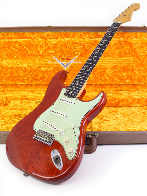 A red Fender Custom Shop guitar with a wooden body, displayed in its case, showcasing its 2019 craftsmanship.