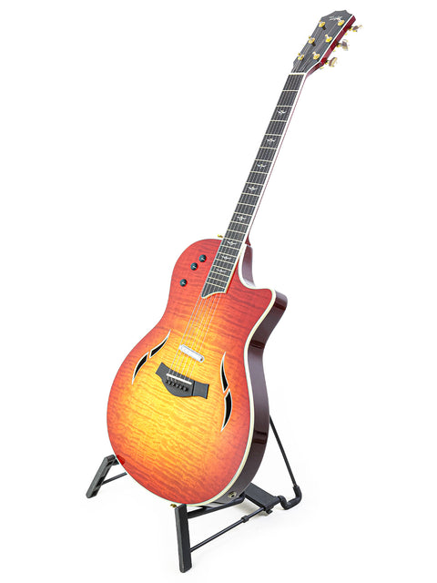 A red sunburst Taylor T5-C1 guitar on a stand, showcasing its USA craftsmanship from 2010.