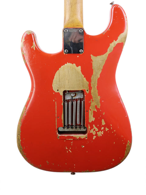A rustic-finished 1964 Fender L Series Stratocaster in Fiesta Red, highlighting its vintage appeal and iconic style.