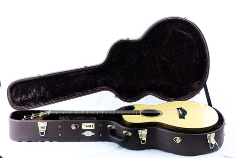  A sleek Taylor Custom GS Baritone 6 guitar nestled in a case, set on a plain white background.
