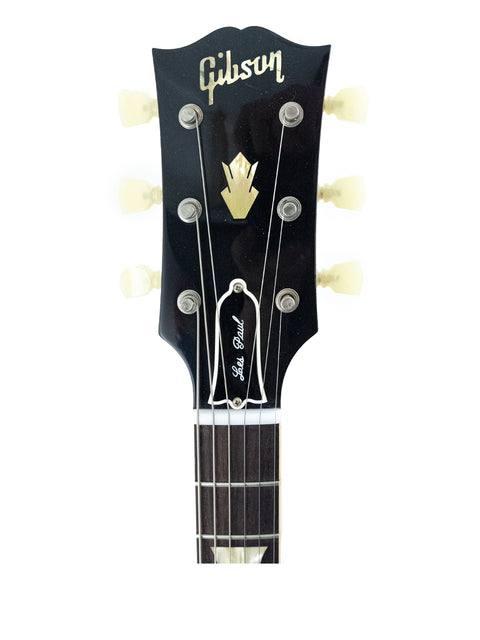 A striking black Gibson Les Paul Custom Shop guitar, '61 SG Standard model from 2020, highlighting its elegant features.
