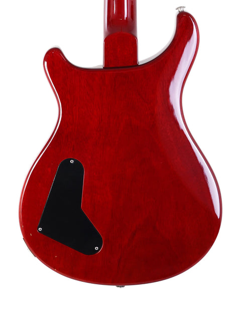 A striking red PRS Custom 22 electric guitar from 2005, featuring a black pickguard for a bold look.