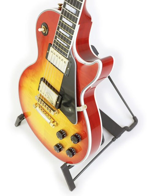 A striking red and black Gibson Les Paul Custom guitar from 2014, elegantly positioned on a stand.