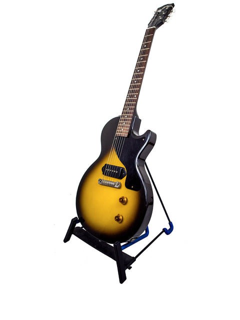 A striking yellow body of a Gibson Custom Shop '57 Les Paul Junior Reissue guitar elegantly positioned on a stand.