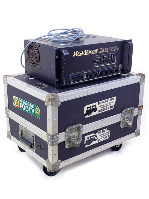 A sturdy case with two amplifiers resting on it, prominently displaying a Mesa Boogie Bass 400+ Head from 1993, ideal for musicians.