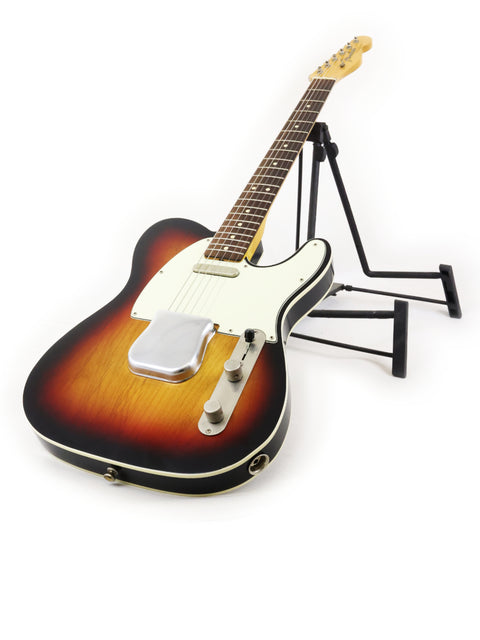 A stylish 2021 Txxx Custom Style Partscaster guitar in sunburst color, resting on a stand, ready to play.