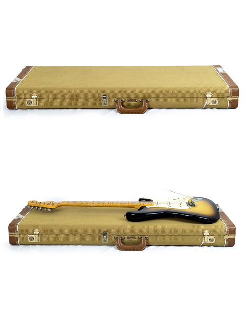 A suitcase opens to reveal a Fender Custom Shop Time Machine 58 Strat Relic guitar nestled in its case, ready for travel.
