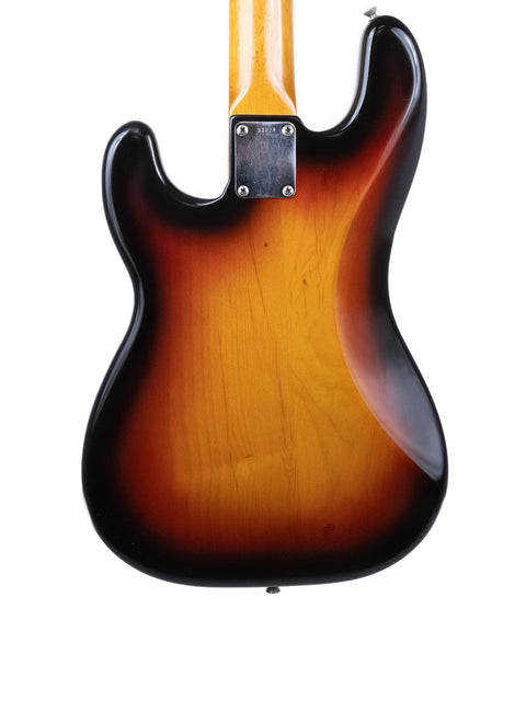 A sunburst Fender American Standard Stratocaster, showcasing its classic design and vibrant color, alongside a vintage Precision Bass.
