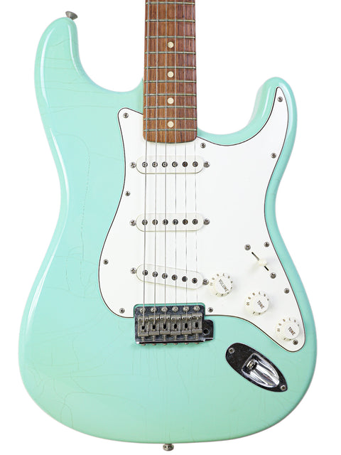 A vibrant green electric guitar, the Fender Custom Shop 1960's Closet Classic Stratocaster, featuring a white pickup from 2003.