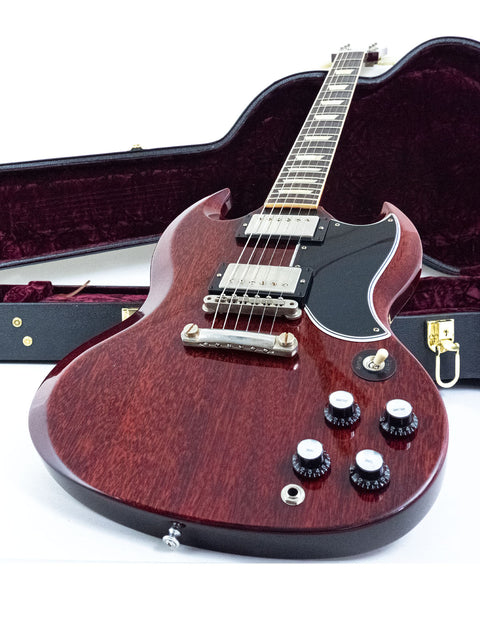 A vibrant red electric guitar, the Gibson Custom ’61 Les Paul SG Standard, securely placed in its protective case.