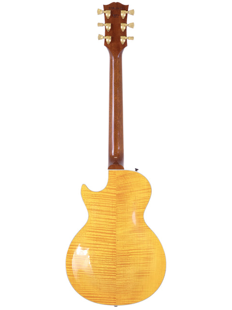 A vibrant yellow Gibson Les Paul Supreme guitar, featuring a wooden body and neck, crafted in the USA in 2003.
