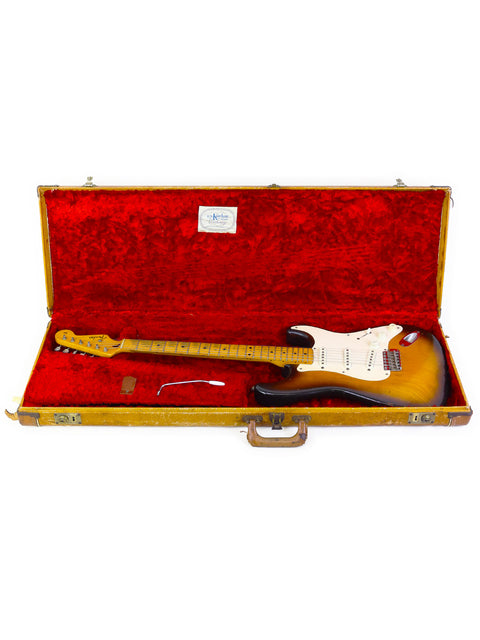 A vintage 1954 Fender Stratocaster, highlighting its elegant curves and timeless craftsmanship in a striking display.