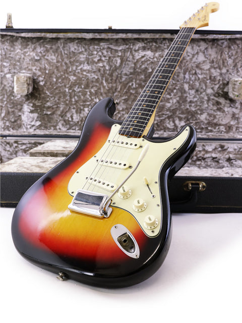 A vintage 1964 Fender L Series Stratocaster in Fiesta Red with a sunburst finish, accompanied by its protective case.