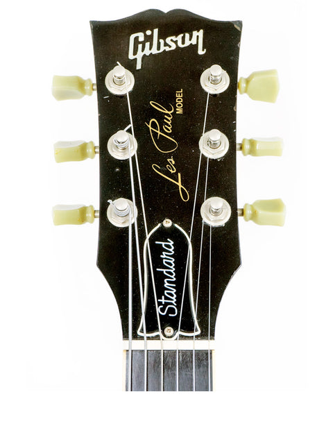 A vintage 1964 Gibson Les Paul Custom guitar displayed with a 1991 Gibson Les Paul Standard, highlighting their iconic features.