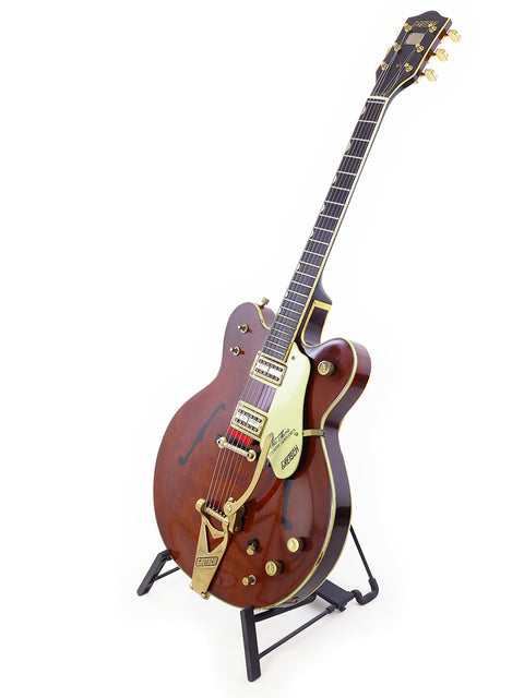 A vintage 1967 Gretsch 6122 Chet Atkins guitar with a wooden body and elegant gold headstock.
