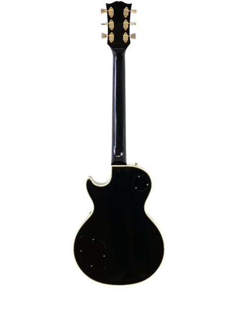 A vintage 1972 Gibson Les Paul Custom electric guitar in black, highlighted by a striking white pickguard.