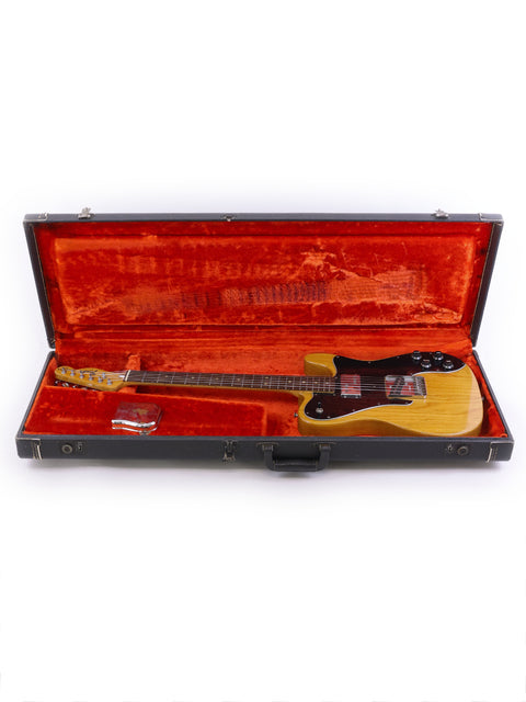 A vintage 1977 Fender Telecaster Custom guitar resting in a case, highlighting its iconic shape and craftsmanship.