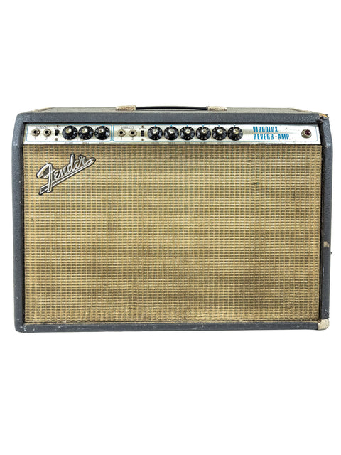 A vintage 1977 Fender Vibrolux Reverb Amp displayed with a contrasting black and white backdrop, highlighting its iconic features.