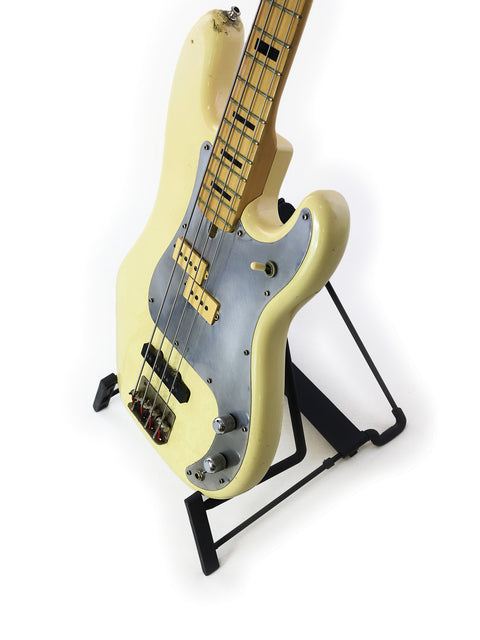 A vintage 1978 Ibanez Silver Series P/J Bass guitar in white, elegantly positioned on a stand, highlighting its iconic style.
