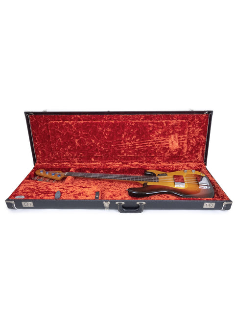 A vintage Fender Precision Bass case with rich red velvet lining, highlighting the elegance of the 1958/59 model.
