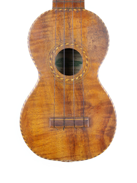 A vintage Manuel Nunes Style #3 ukulele with a wooden body and neck, crafted around 1917.