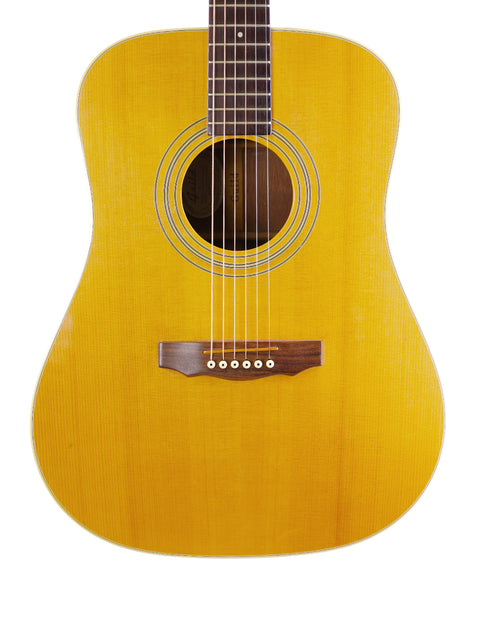 A vintage yellow Guild D40 acoustic guitar from 1989 set on a bright white background.