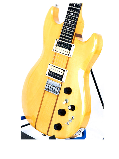 A vintage yellow electric guitar, the Aria Pro II TS 400 from 1980, elegantly positioned on a stand, highlighting its unique style.