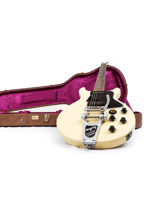 A white 1959 Gibson Les Paul Special Refin guitar displayed in a pink case, highlighting its vintage charm.