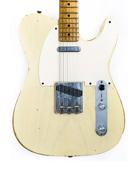 A white Fender Custom Shop guitar with a wooden body and black pickup, showcasing its unique design from 2006.
