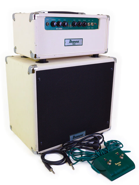 A white Ibanez TSA15 Tube Screamer head paired with a green amplifier, representing a sleek audio configuration from 2010.