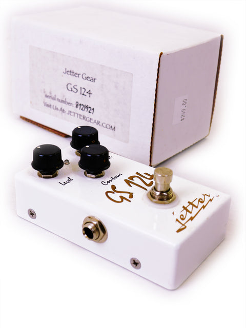 A white Jetter GS124 Dumble Clone guitar pedal with a box beside it, showcasing its sleek design and packaging.
