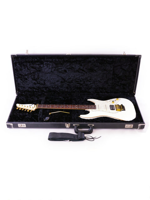 A white Tom Anderson Drop Top Classic electric guitar in a black case, showcasing its sleek design and craftsmanship.