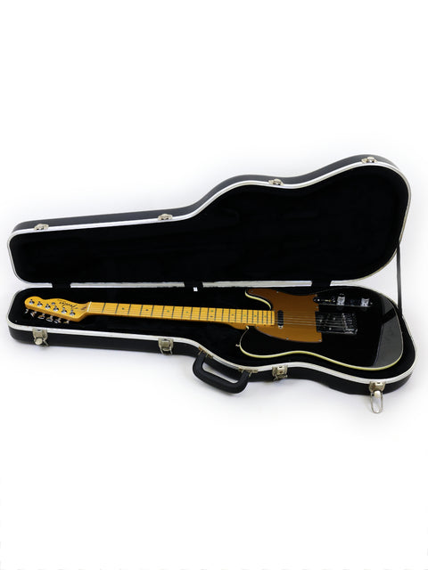 A white background showcases a Fender American Deluxe Telecaster guitar securely housed in its case.