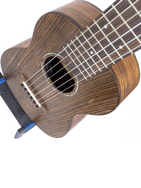 A wooden acoustic guitar displayed upright against a white background.