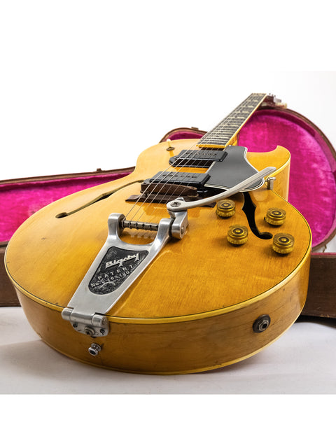 A yellow 1953 Gibson ES 175 DN guitar, complete with a case and strap, highlighting its vintage appeal and style.
