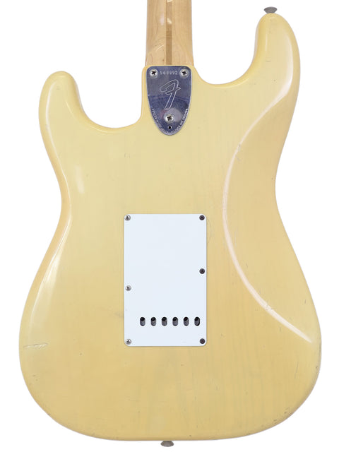 A yellow Fender Custom Shop Stratocaster, vintage 1954 model, exemplifying iconic American guitar artistry.