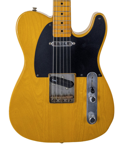 A yellow Fender Squier JV Telecaster guitar with a black pickup, showcasing its vintage 1984 design and vibrant color.