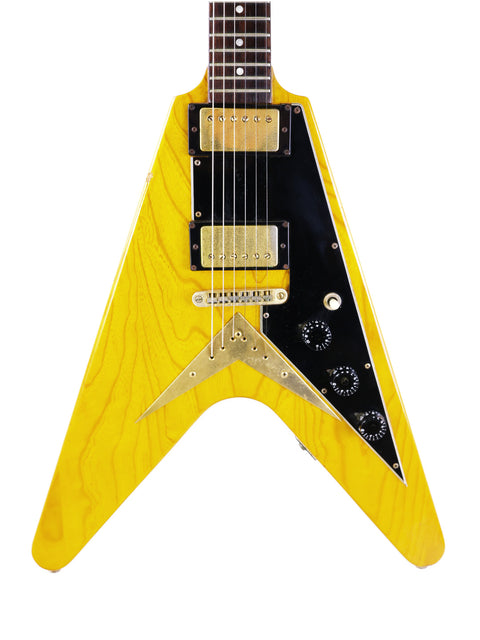 A yellow Ibanez 2387CT Rocket Roll Sr. Flying V guitar featuring black and gold hardware, from Japan, 1976-77.